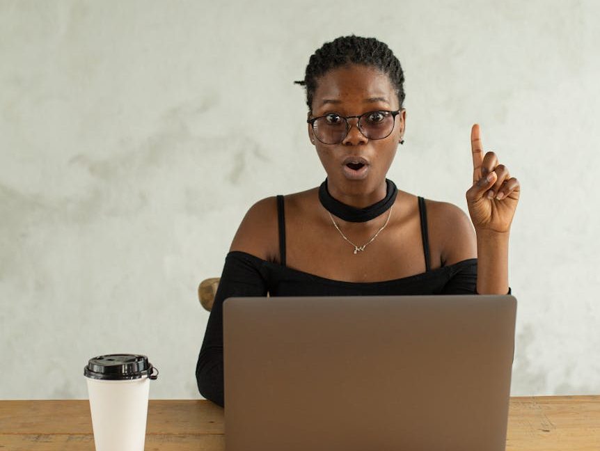 excited black woman using laptop