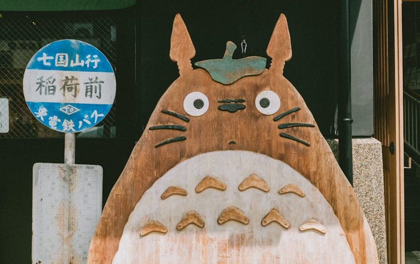 a wooden animal carving beside a street sign