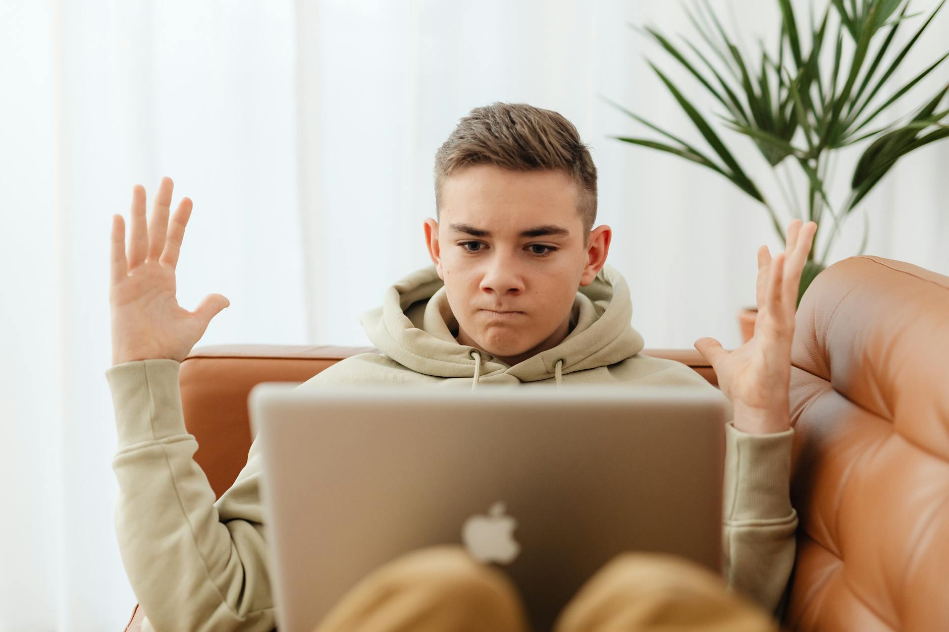 a young boy looking at his laptop