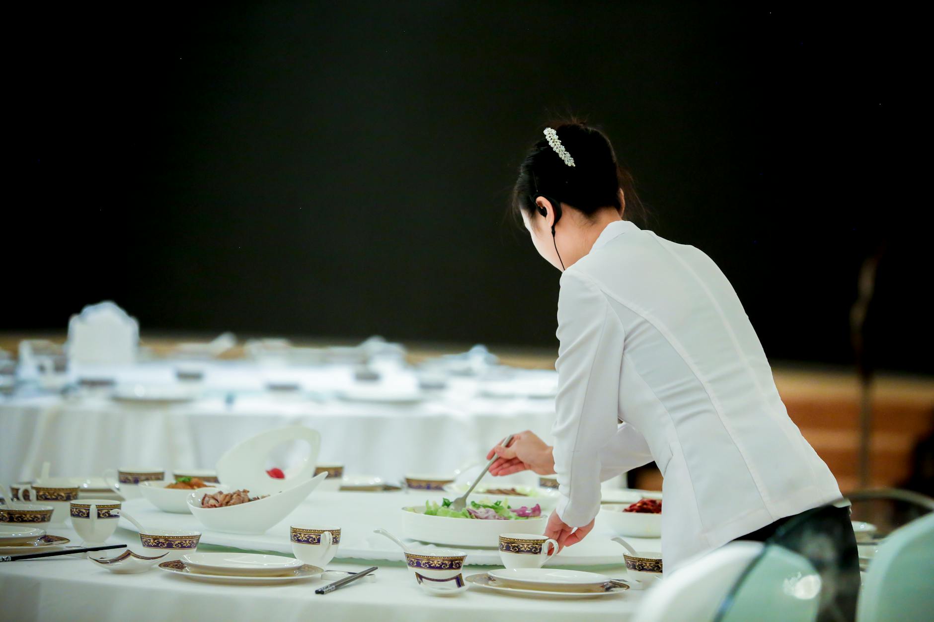 woman preparing dish on table
