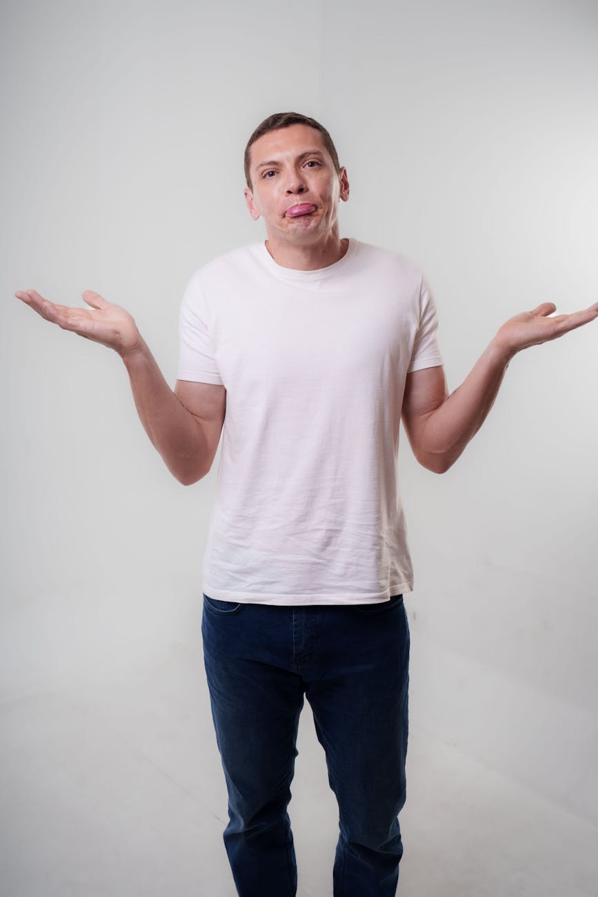 man shrugging in studio with neutral expression